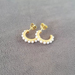 Gold pearl half hoop earrings